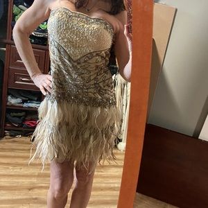 Beaded gown with ostrich feathers